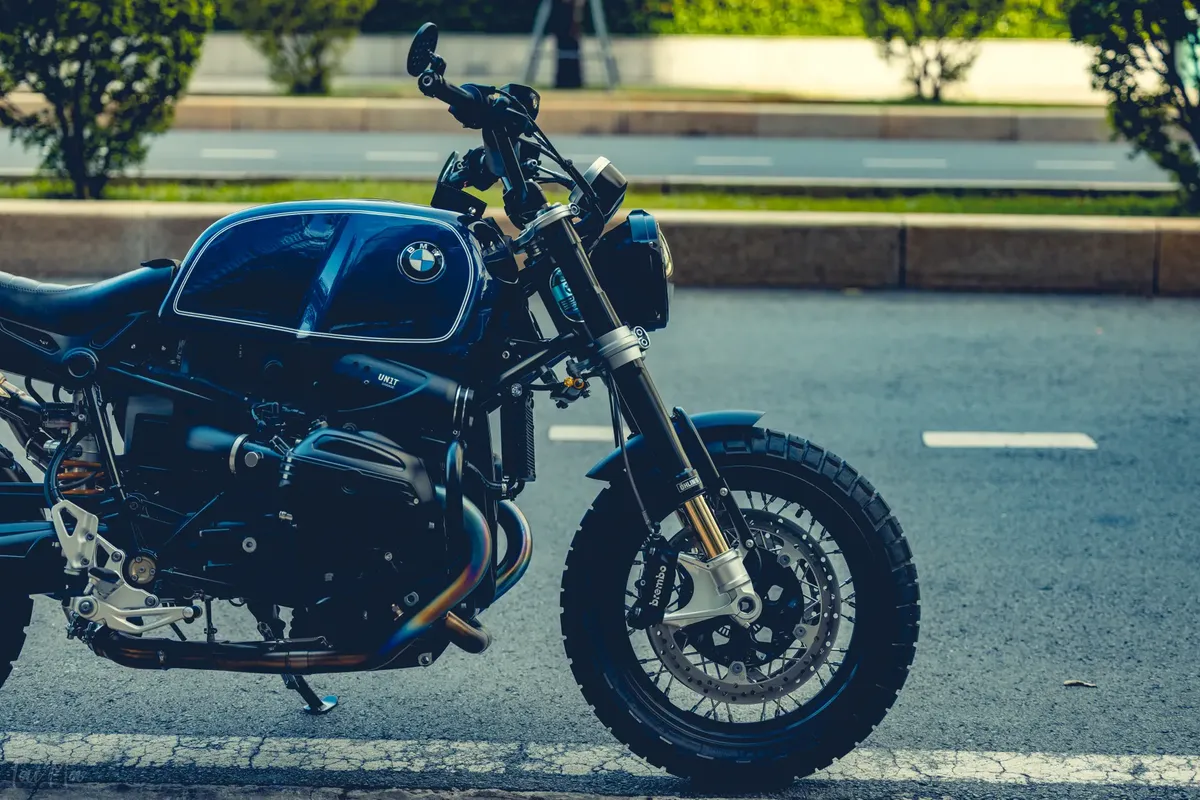 Stylish BMW motorcycle parked on city roadside reflecting urban elegance.