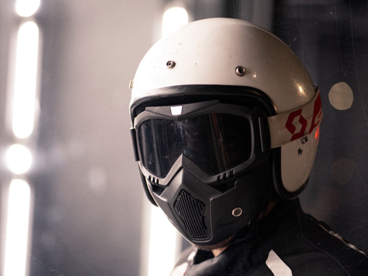 Close-up of a motorcycle helmet visor showing scratches and reflections
