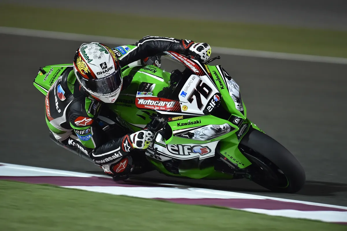 High-speed motorcycle racer performs a thrilling corner maneuver on a sports bike at night.